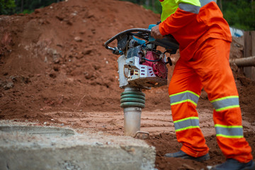 Man holding soil compactor