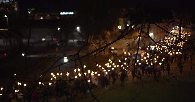 Torchlight procession at night people walking with burning torches