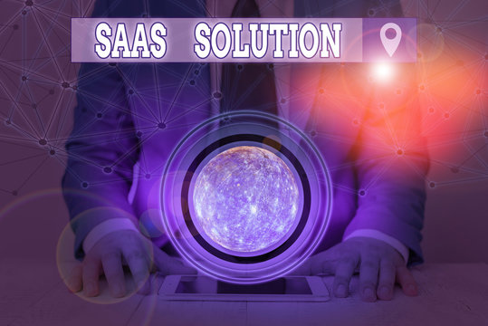 Handwriting text Saas Solution. Conceptual photo software delivery method that provides access to software Elements of this image furnished by NASA