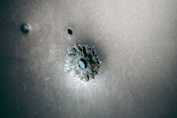 Bullet hole on a metal sheet