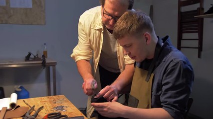 Master shows how to hammer a nail into a shoe 