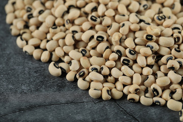 White dry beans spread over the right top corner of the table
