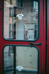 Fototapeta na wymiar Old red telephone box in the city
