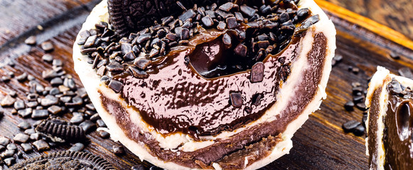 brazilian easter egg with spoon. Easter with refined chocolate, covered with sprinkles, cut in half. Black and white chocolate and chocolate chip cookie with sprinkles.