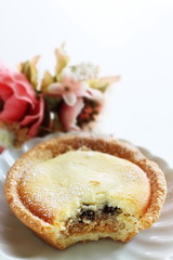 Raisin and cheese tart on white dish for gourmet dessert