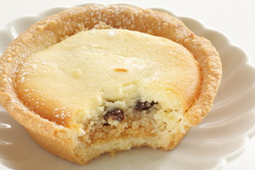 Raisin and cheese tart on white dish for gourmet dessert