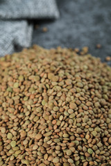 Green fresh and healthy lentil on the bottom side of the background