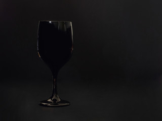 black wine glass on black background