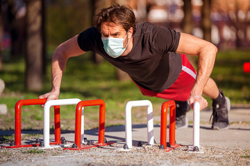Single male on the training, street workout, with mask preventive of corona virus