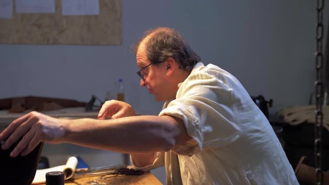 Master sits and talks about creation of shoes