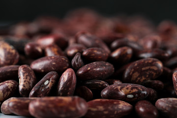 Fresh and healthy red beans, dry seeds on black background