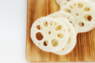 freshness lotus roots sliced on wooden board with copy space