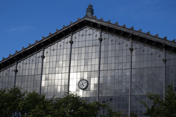 Clock on the glass facade of an old building