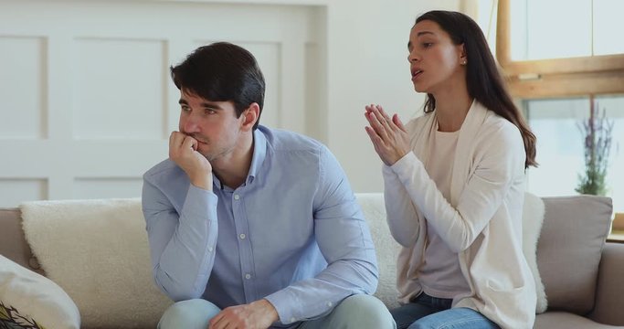 Funny guilty millennial girl pleading begging forgiveness for mistake. Young upset wife feeling remorse says sorry regrets for jealousy apologizing annoyed husband rejects to forgive. Apology concept