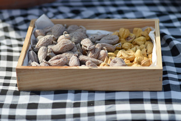 dried figs and chestnuts on checkered tablecloth
