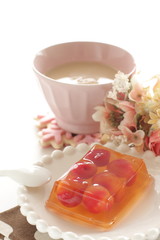 Cherry jelly on plate with tea for dessert
