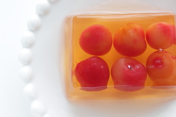 Cherry jelly on plate with tea for dessert
