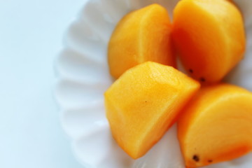 Chopped persimmon on white dish for gourmet dessert