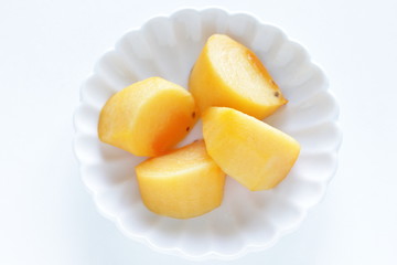 Chopped persimmon on white dish for gourmet dessert