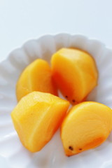 Chopped persimmon on white dish for gourmet dessert
