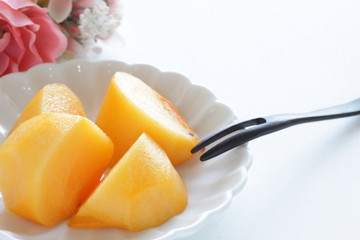 Chopped persimmon on white dish for gourmet dessert