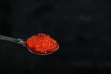 Red caviar in a metallic spoon