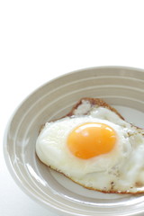 homemade  sunny side up fried egg on dish