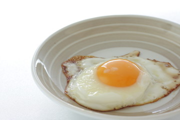 homemade  sunny side up fried egg on dish