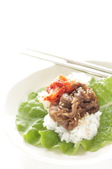 Korean food, grilled beef and kimchi on rice wrapped by lettuce