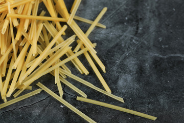 Homemade fresh spaghetti on the top corner side of the background