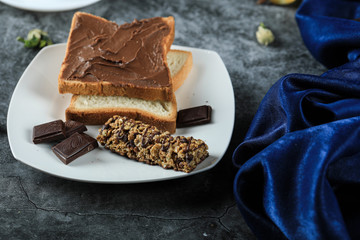 Chocolate bread toast with chocolate pieces in a white saucer