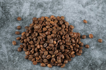 Fresh coffee beans in the middle of the background