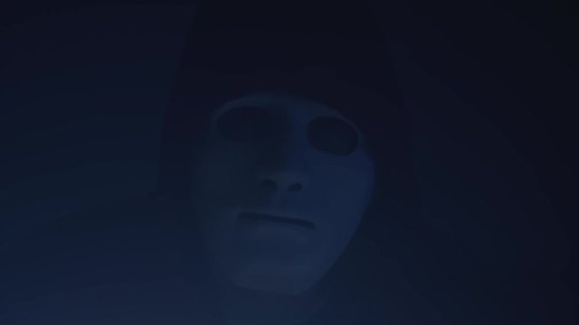 threatening look of the man with white mask and hoodie. Anonymous hacker sending threatening message