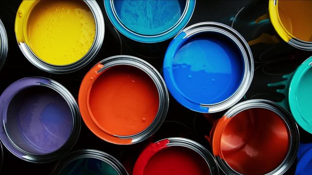 Aluminium cans with vivid, colorful paint inside stacked on the floor of a warehouse. top view slider wiring