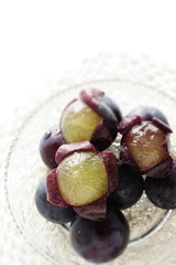 peeled Japanese grape on dish with copy space