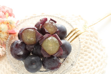 peeled Japanese grape on dish with copy space