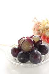 peeled Japanese grape on dish with copy space