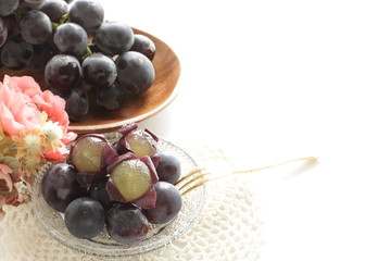 peeled Japanese grape on dish with copy space
