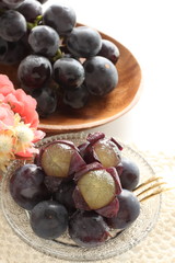 peeled Japanese grape on dish with copy space