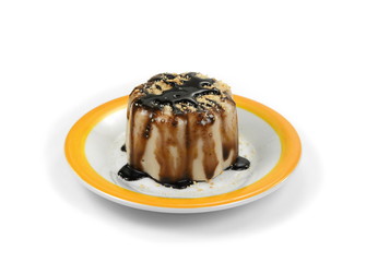 Hazelnut caramel pudding sprinkled with ground biscuits isolated on white background.