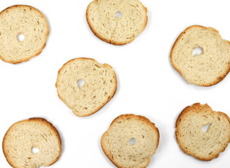 Bake rolls. Mini bread chips isolated on white background. Round bread slices.