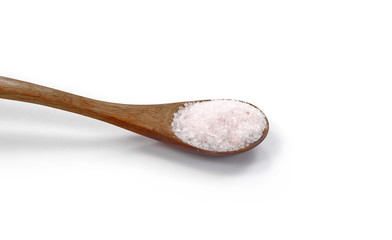 Himalayan salt in a wooden spoon isolated on white background.