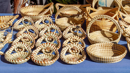 Fototapeta premium Sweetgrass Baskets, beautiful handicrafts of African origin, on display at historic Charleston City Market in Charleston, South Carolina.