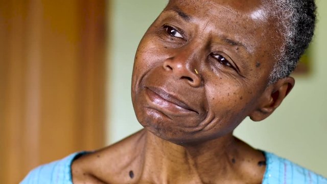 Senior black woman subtly changing her mind from a negative to positive emotion