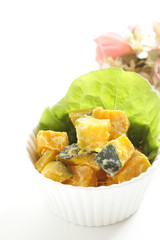 Homemade pumpkin salad in bowl with copy space