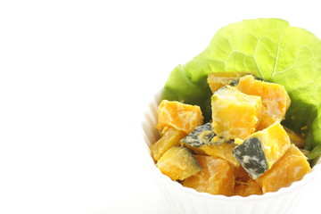 Homemade pumpkin salad in bowl with copy space