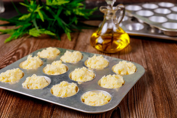 Uncooked brazilian cheese bread in baking pan with oil.
