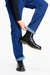 Male model in blue jeans bottom on white background.