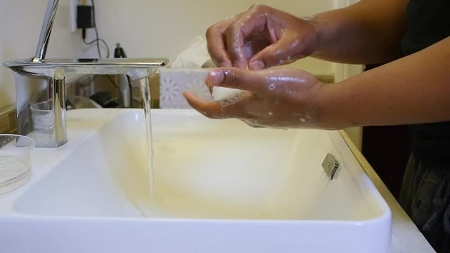 Black man washing hands in slow motion