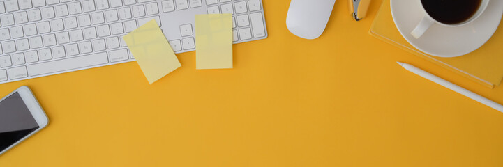 Cropped shot of computer device on yellow background